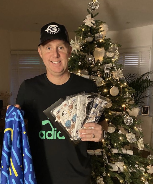 Stripey Green TV's Rob holding prizes from FreshGrip's Instagram competition